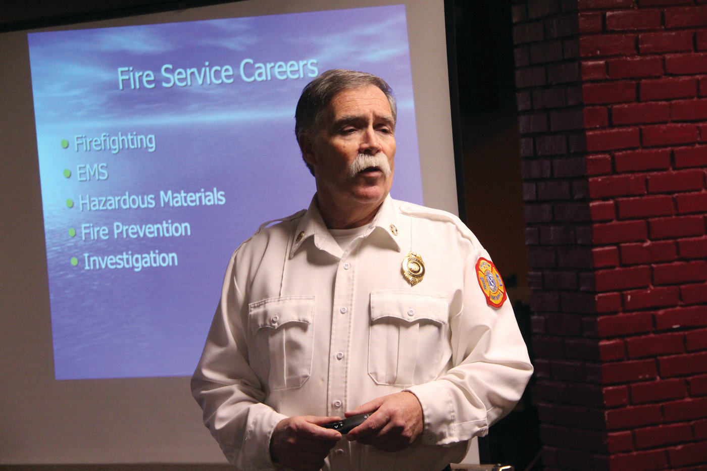 WHAT IT IS TO BE A FIREFIGHTER: Cranston Fire Chief William McKenna outlines career opportunities to scouts taking his class.